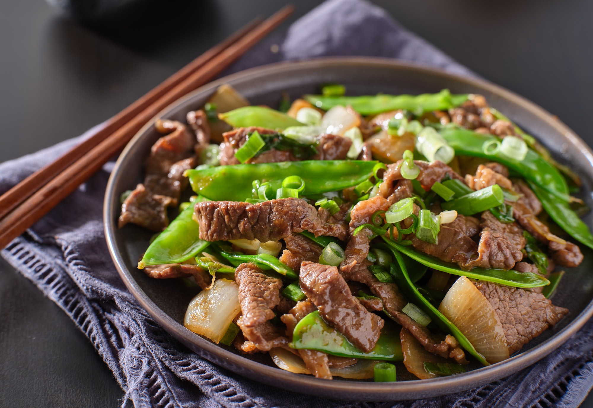 chinese beef and snowpeas stirfry on plate